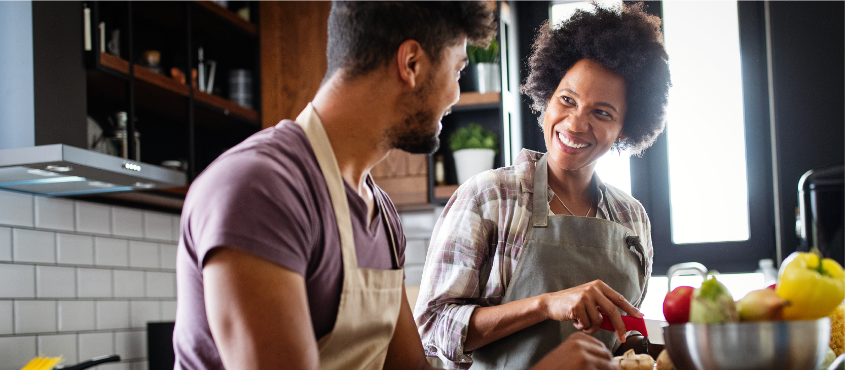 Smiling couple cooking at home together